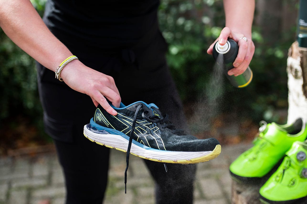U-Sport Shoe Impregnator wordt op een hardloopschoen gespoten voor optimale bescherming